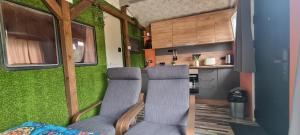 a living room with two chairs in a tiny house at Lion Cottage in Chuprene