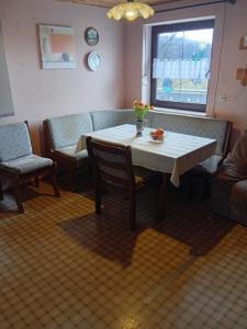 a living room with a table and a couch at Ferienwohnung Baumann Alois in Furth im Wald +10 photos