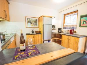 a kitchen with a bottle of wine on a table at Apartment Am Weitfeld-2 by Interhome in Längenfeld