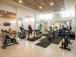 a gym with many exercise bikes and treadmills at Apartment Bayview Collection free Spa & Padel by Interhome in Torrox Costa