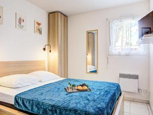 a bedroom with a bed with a tray of fruit on it at Apartment Atrium by Interhome in Caves
