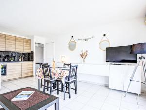 a kitchen and dining room with a table and chairs at Apartment Atrium by Interhome in Caves