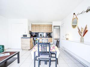 a kitchen and dining room with a table and chairs at Apartment Atrium by Interhome in Caves +13 photos