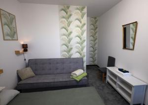 a living room with a couch and a table at Stacja Binino in Binino