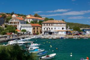 a group of boats are docked in a harbor at Apartments Martina near the beach in Šilo