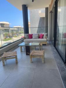 a living room with a couch and a table and benches at Almaza Bay in Alexandria