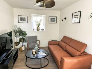 a living room with a couch and a table at Holiday Home Le petit Papeu by Interhome in Frehel +19 photos