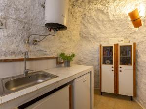 a kitchen with a sink and a counter top at Holiday Home Cueva Mariana Pineda by Interhome in Terque