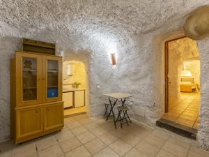a kitchen with a table and a small table at Holiday Home Cueva Mariana Pineda by Interhome in Terque