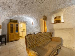 a living room with a couch in a stone room at Holiday Home Cueva Mariana Pineda by Interhome in Terque +25 photos