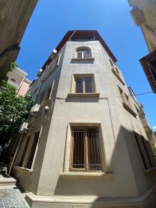 a tall building with barred windows on the side of it at SaraSofi Hotel in Baku