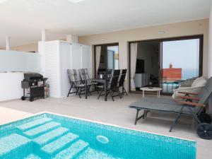 a living room with a pool and a table and chairs at Apartment Heaven Free Spa & Padel by Interhome in Torrox Costa