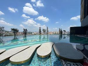 a swimming pool with benches in a building at Arte cheras By comport corner in Kuala Lumpur