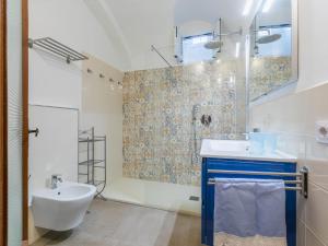 a bathroom with a sink and a toilet and a shower at Apartment Torre degli Amidei by Interhome in Volterra