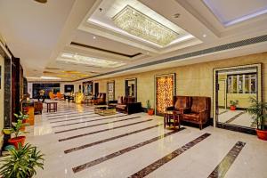 a lobby with couches and chairs in a building at Super Townhouse OAK Hotel City Mark Gurgaon in Gurgaon +68 photos