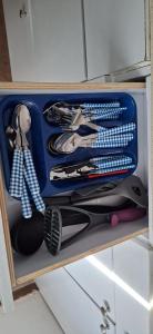 a blue drawer filled with lots of utensils at ורד אירוח in Eilat