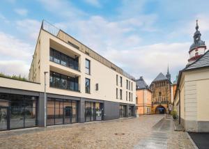 an empty street in a city with buildings at Limehome Chemnitz Kirchgässchen in Chemnitz