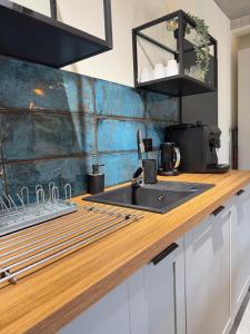 a kitchen with a sink and a counter top at Apartament w górach ze SPA in Szczyrk +12 photos
