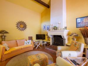 a living room with a couch and a fireplace at Holiday Home Font Mourier by Interhome in Cogolin