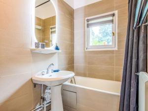 a bathroom with a sink and a mirror at Apartment La Pinchonnière-8 by Interhome in Tourgeville