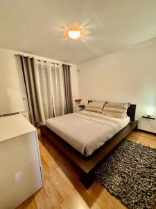 a bedroom with a bed and a ceiling fan at Casa Vacanze Vigolana in Centa San Nicolò +17 photos