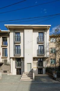 a white building with balconies on the side of it at AER Apart & Wine in Eforie
