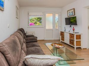 a living room with a couch and a glass table at Holiday Home Gordana by Interhome in Maslenica