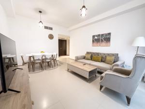 a living room with a couch and a table at 1Bedroom Apartment with Stunning Partial Sea View Pacific Al Marjan in Ras al Khaimah +7 photos