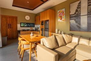 a living room with a couch and a table at Villa Sattvika in Kerobokan