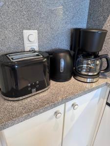 a counter with a microwave and a coffee maker and a toaster at Appartement ALEXANDRA by MoniCare in Seefeld in Tirol