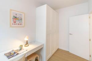 a white desk with a lamp on it in a room at Acogedor Loft a 15 minutos del centro de Pamplona in Pamplona +25 photos