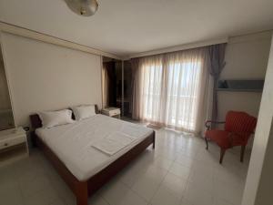 a bedroom with a large bed and a red chair at Panorama Hills Villa with Pool in Thessaloniki +47 photos