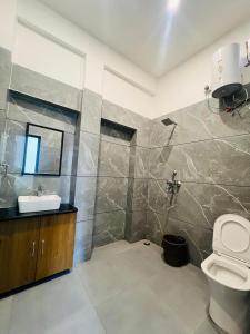 a bathroom with a toilet and a sink at White Poppy Lake Side Hostel in Udaipur