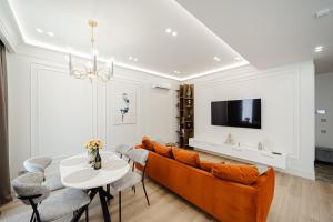 a living room with a couch and a table at Modern 1BD - Apartment in Chişinău