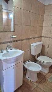 a bathroom with a toilet and a sink at Excelente Bungalow en San José, Entre Ríos in San José +12 photos