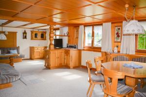 a kitchen and dining room with a table and chairs at Villa Mondschein in Au im Bregenzerwald