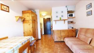 a room with a bed and a couch at Residenza Giardino in Aprica