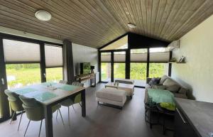 a living room with a table and a couch at Vakantiepark de Zeeuwse Parel - de Parel in Sint Maartensdijk