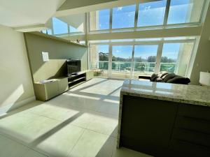 a large living room with a large window at Atlântida Green Square - 607A in Xangri-lá +46 photos
