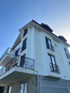 a white building with balconies on the side of it at Panorama villa in Akcaabat