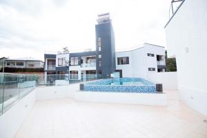 a building with a swimming pool in front of a building at Cascadia Apartments Kigali in Kigali
