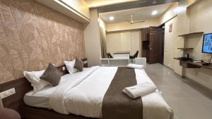 a bedroom with a large bed in a room at Hotel Prime Suites - Baner in Pune
