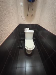 a bathroom with a toilet and a phone on the wall at Затишна квартира на березі Дніпра in Cherkasy +7 photos