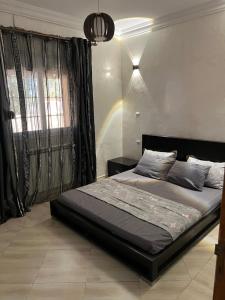 a bedroom with a bed with a rainbow in the wall at Villa Caprosa à côté du lac in El Kala