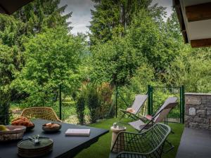 a patio with a table and chairs and a grill at Lodge Sami - OVO Network in Samoëns +11 photos