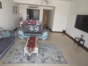 a living room with a couch and a table at بورتو كايرو التجمع الخامس in Cairo