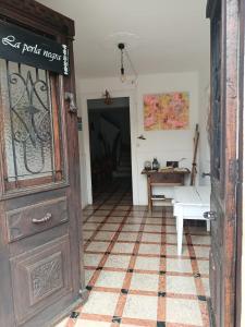 an entrance to a room with a table and a door at Casa de pelegrinos la perlanegra  +2 photos