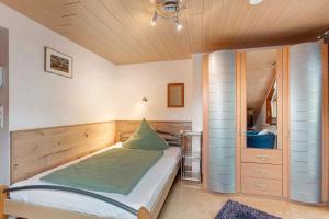 a bedroom with a bed and a wooden ceiling at Ferienwohnung Schweizer in Bernau im Schwarzwald