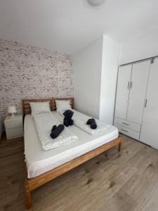 a bedroom with a bed with two black hats on it at Loft Old Town Bucharest in Bucharest