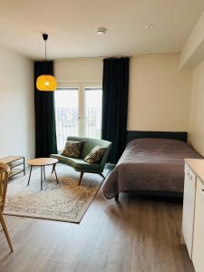 a bedroom with a bed and a couch and a table at Kiva yksiö kahdelle in Turku